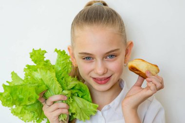 Genç kız bir marul ve izole pişirme arasında seçer
