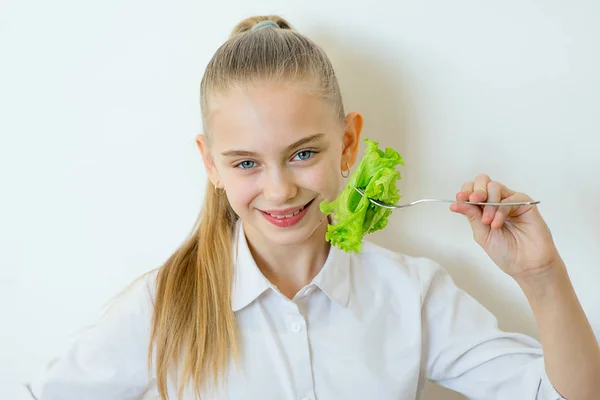 Menina fitness feliz segurando garfo com alface isolada — Fotografia de Stock