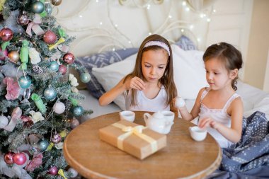 Çocuk kız yatağında Noel sabah uyanıp