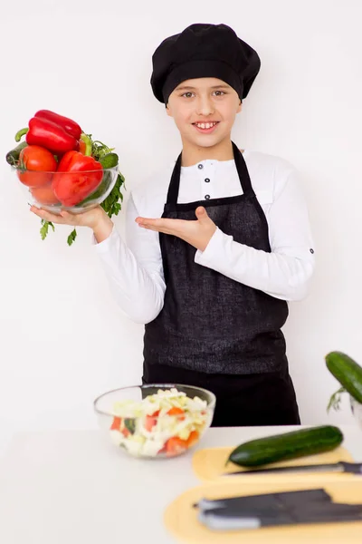 年轻的男孩抱着一盘蔬菜与隔离 — 图库照片