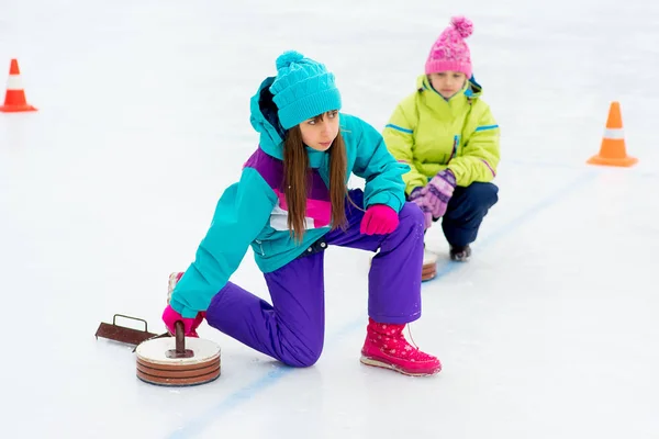 Junge Mädchen spielen Eisstockschießen — Stockfoto