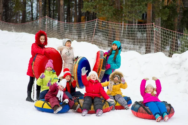 Barnen på snö rör neråt på vinterdag — Stockfoto