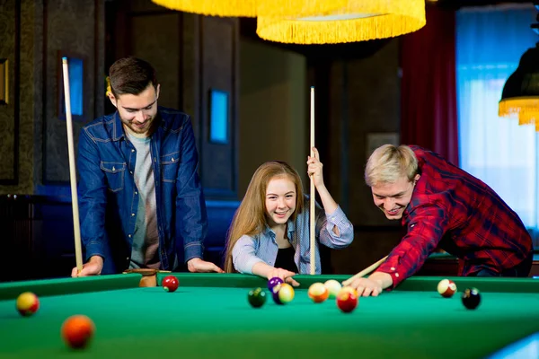 Friends Cheering While Their Friend Aiming For Billiards Ball