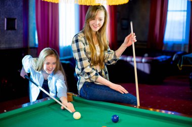 iki kız bilardo oynarken