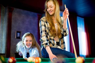 iki kız bilardo oynarken