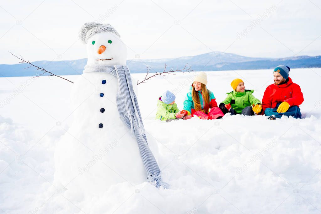 Family sitting in snow