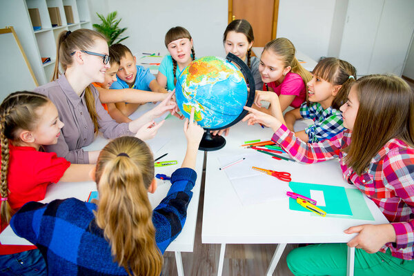 Kids pointing at globe