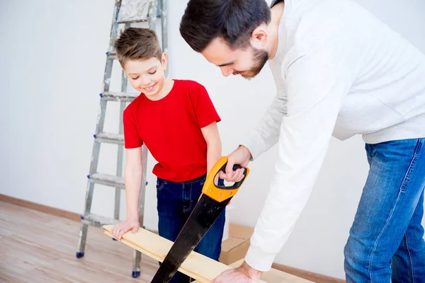 Father and son with saw