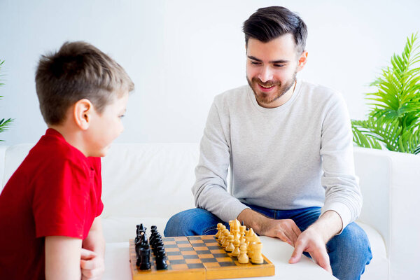 Father and son playing chess