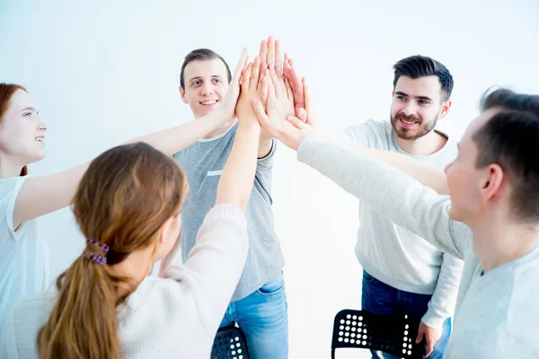 Group of people giving high five — Stock Photo, Image