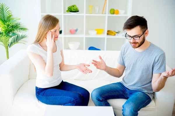 Pareja cariñosa jura en el sofá — Foto de Stock