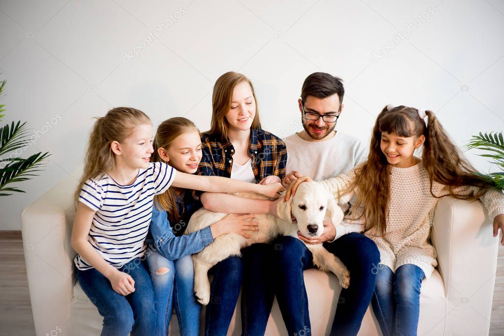 Family playing with a dog