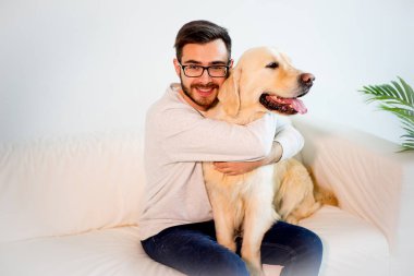 Adam köpeğiyle oynuyor.