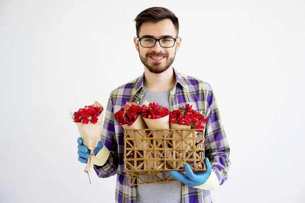 Male gardener with flowers — Stock Photo, Image