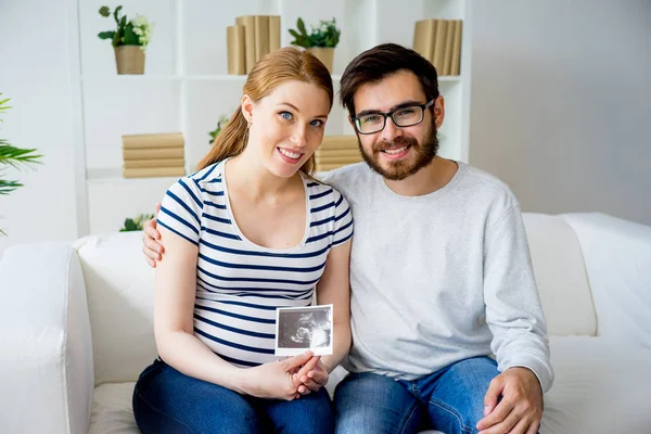 Pareja sosteniendo ecograma — Foto de Stock