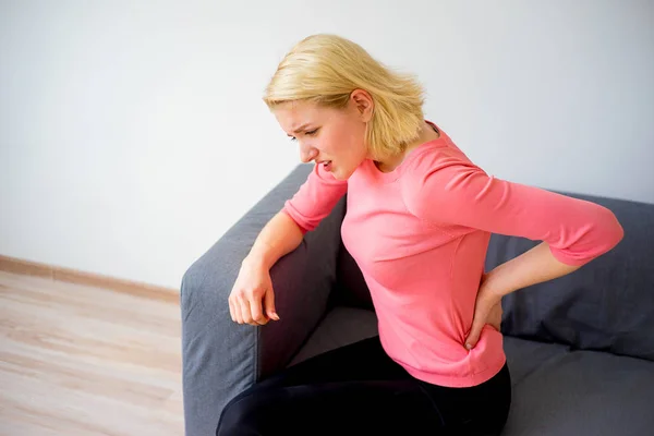 Girl sprained her back — Stock Photo, Image
