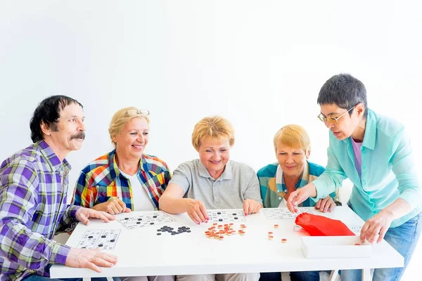 Senior people playing board games