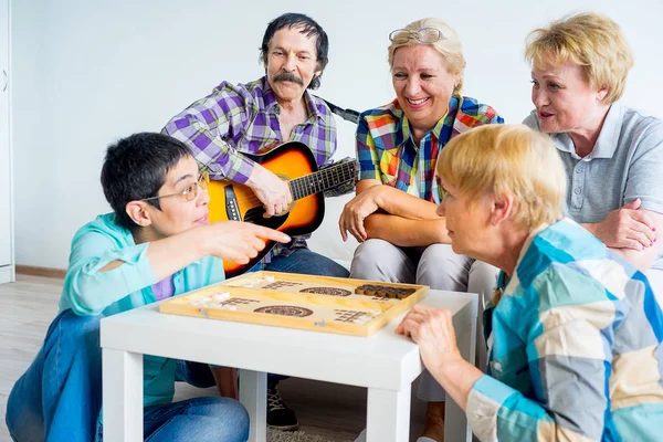 Senior people playing board games