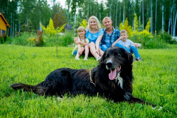 Family picnic with a dog — Stock Photo, Image