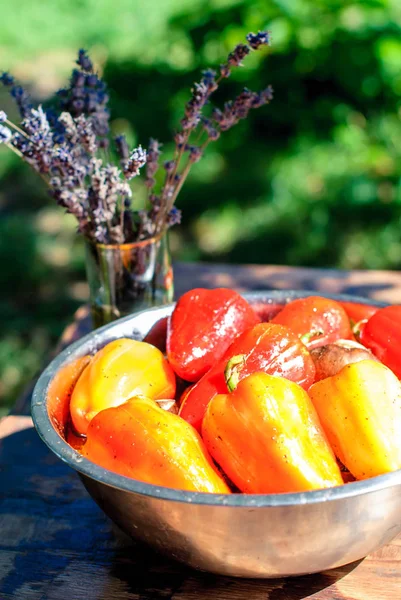 Red and yellow salad peppers in marinade for grilling and a bouquet of lavender on the summer table — Stock Photo, Image
