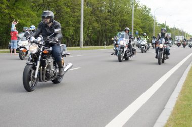 Bikers on their motorcycles in special clothes ride a collar on the outskirts of the city of Brest at the annual international festival of bikers on May 27. clipart