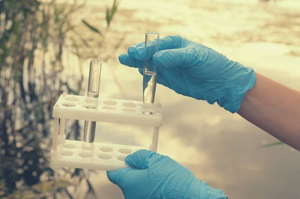 Taking a water test for analysis from a reservoir.