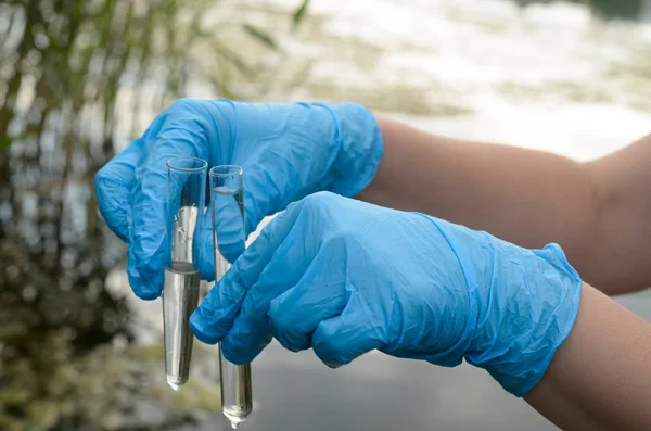 Taking a water test for analysis from a reservoir.