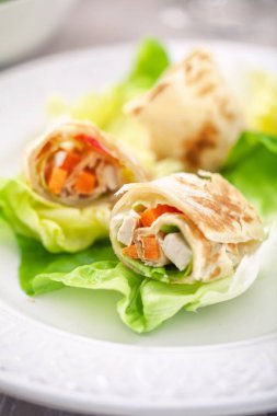 Tavuklu sandviçi tabağa sar.