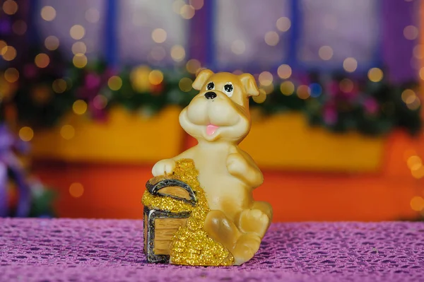 Toy dog on the background of Christmas tree — Stock Photo, Image