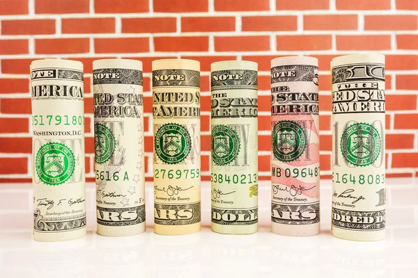 Rolls of american dollar banknotes in one row — Stock Photo, Image