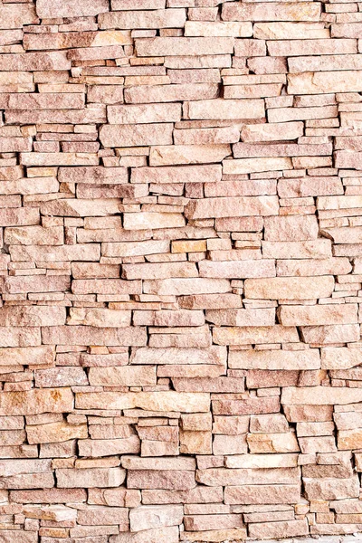 Textured background made of light red stones wall — Stock Photo, Image