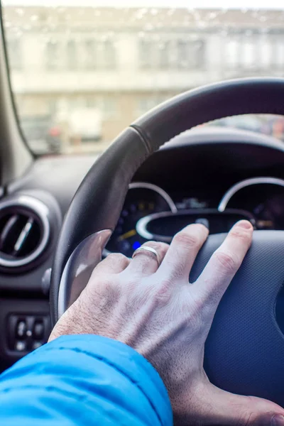 holding driving wheel with left hand