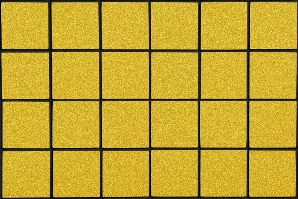 Golden ceramic tile with 24 squares in rectangular form with black filling — Stock Photo, Image