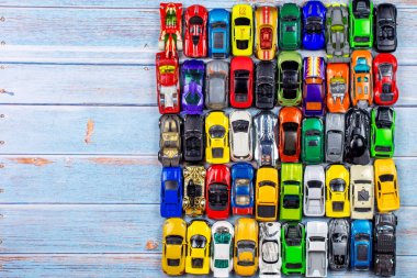 top view of many little car miniature on wooden background 