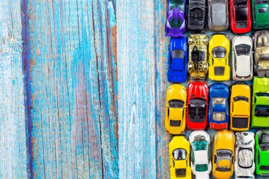 top view of many little car miniature on wooden background 