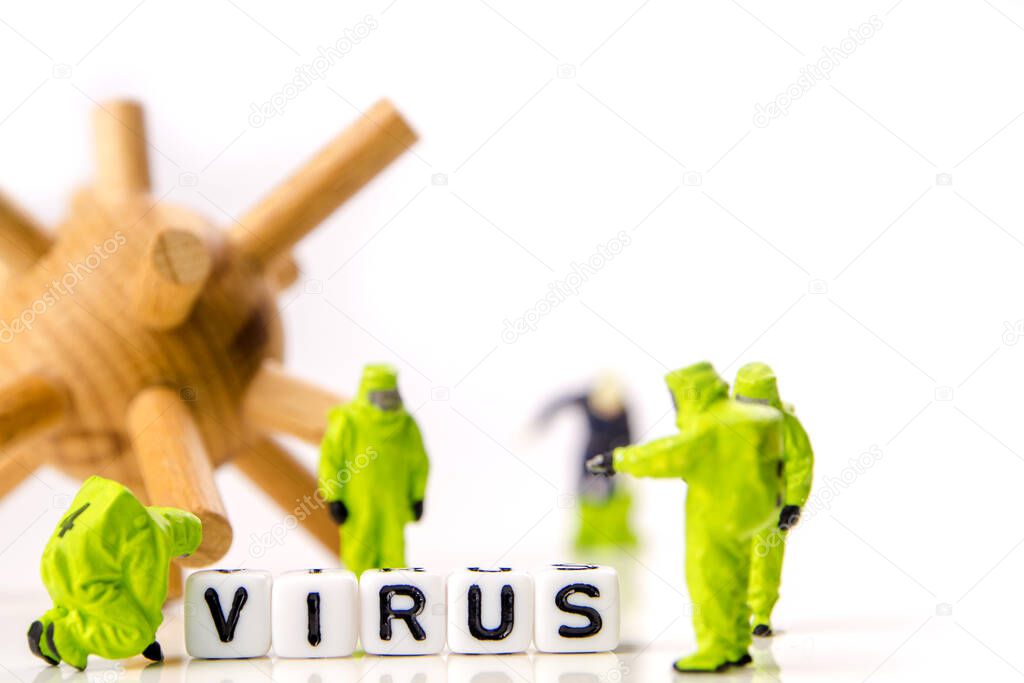 closeup of big corona virus with a team of special medical forces miniature figurines interfering during gas and other chemical accidents, the team preparing for diagnosis and action against very dangerous deadly virus type with the text 