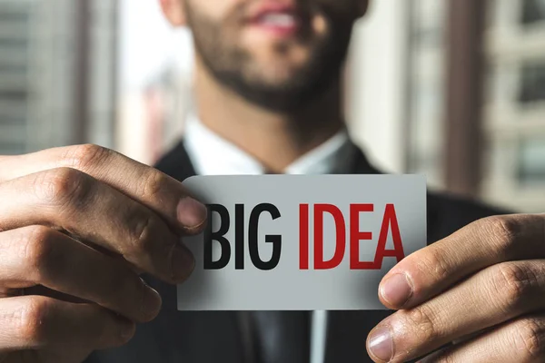 Businessman holding paper with sign — Stock Photo, Image