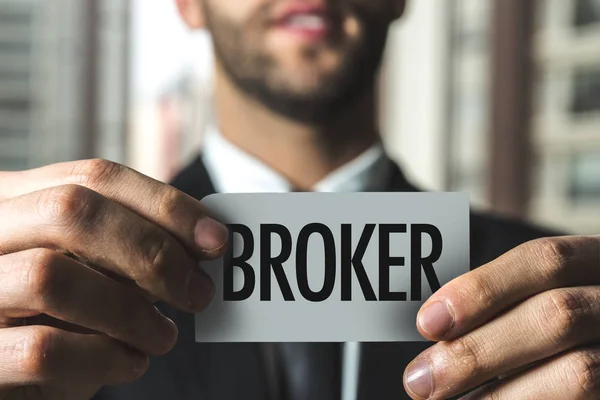 Businessman holding paper with sign — Stock Photo, Image