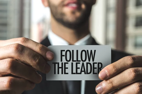 Businessman holding paper with sign — Stock Photo, Image