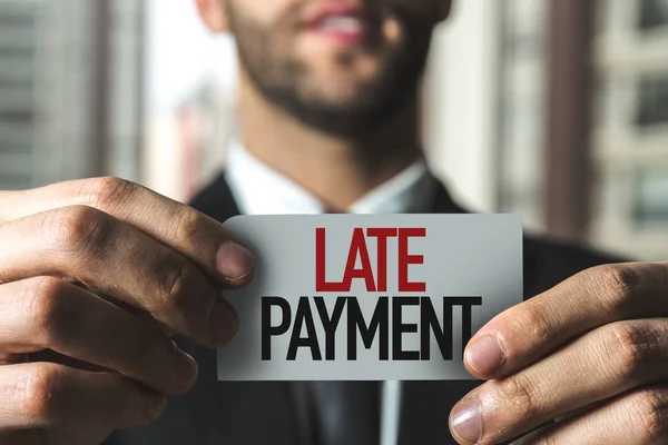 Businessman holding paper with sign — Stock Photo, Image