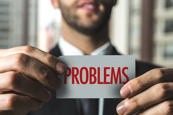 Businessman holding paper with sign — Stock Photo, Image