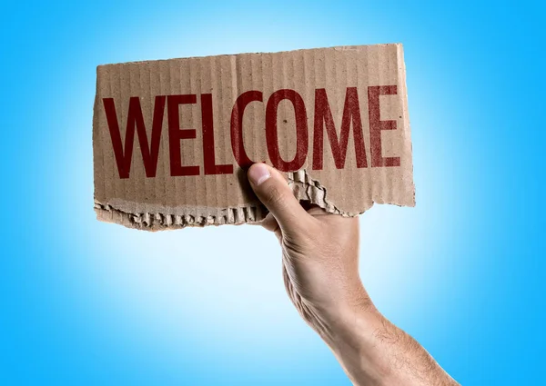 Cardboard with sign welcome — Stock Photo, Image