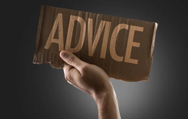 Hand holding cardboard with sign — Stock Photo, Image