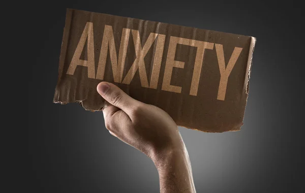 Hand holding cardboard with sign — Stock Photo, Image