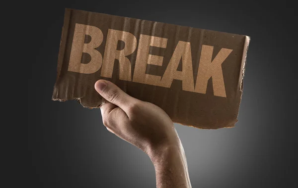 Hand holding cardboard with sign — Stock Photo, Image