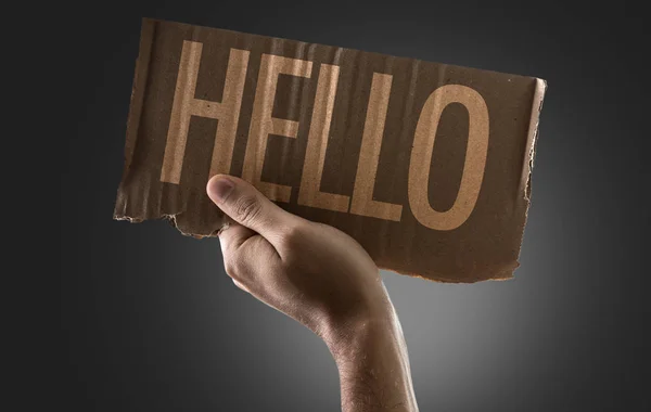 Hand hält Karton mit Schild — Stockfoto