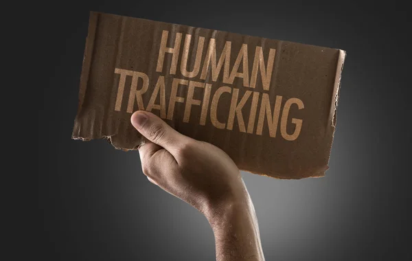 Hand holding cardboard with sign — Stock Photo, Image