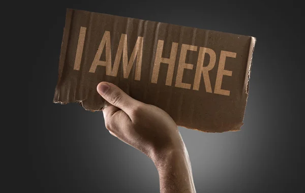 Hand holding cardboard with sign — Stock Photo, Image