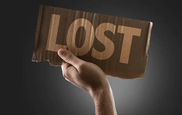 Hand holding cardboard with sign — Stock Photo, Image