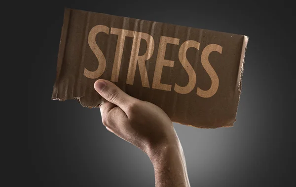 Hand holding cardboard with sign — Stock Photo, Image